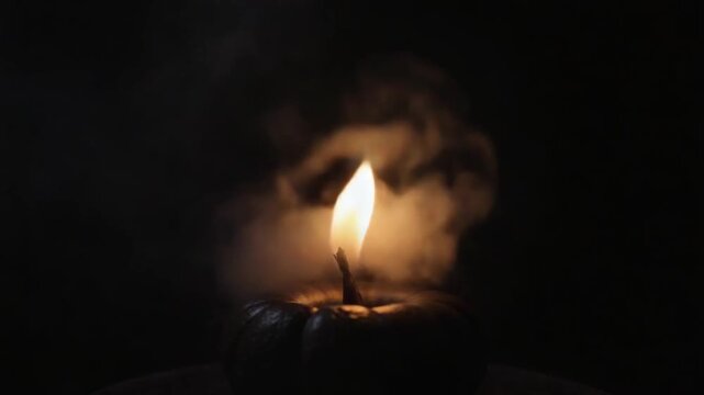 Black magic candles burn. Smoke on the background of the magical attributes of black art. Halloween concept.
