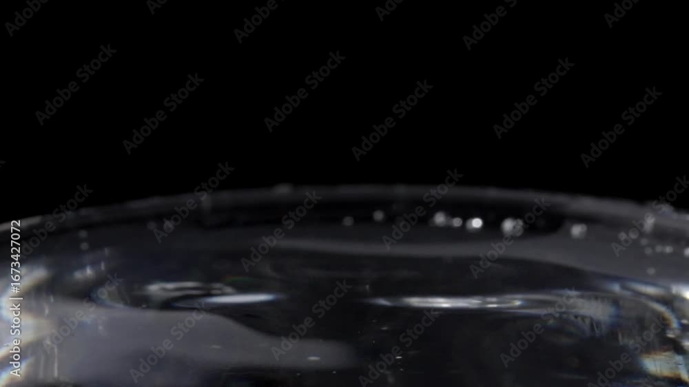 Poster close-up ripples from a splashing drop. macro shot