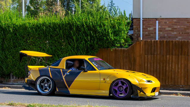 Bletchley,Bucks,UK - Aug 25th 2025: 1994 yellow Mazda mx5 car driving on a British road