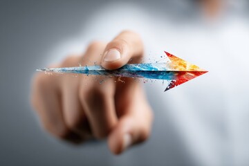 Hand points to a colorful, abstract arrow