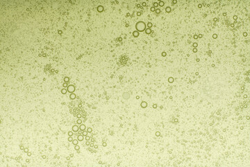 Macro microscope green bubble texture, Close-up Green bubbles and drops oil background . blue green water bubbles, close up golden oil drop for cosmetic