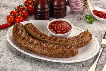 Grilled beef sausages with sauce