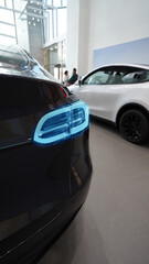 Business Discussion in Luxury Car Showroom with Hybrid Vehicle
