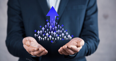 Growth arrows increase planning business target to successful. Businessman holding arrows goal to...