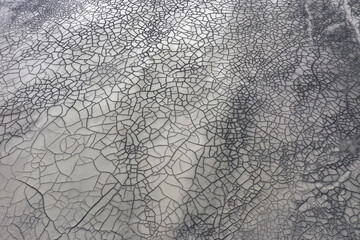  Aerial view of gray abstract mud patterns and cracks on acid mine drainage surface