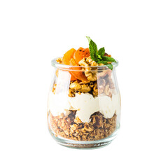 Yogurt parfait in glass jar with granola and fruit