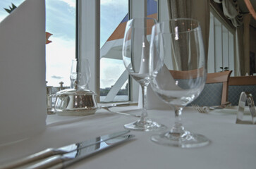 Formal elegant restaurant dining room onboard luxury cruiseship or cruise ship liner with set...
