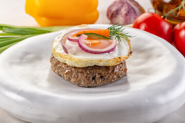 Beefsteak chop with roasted egg
