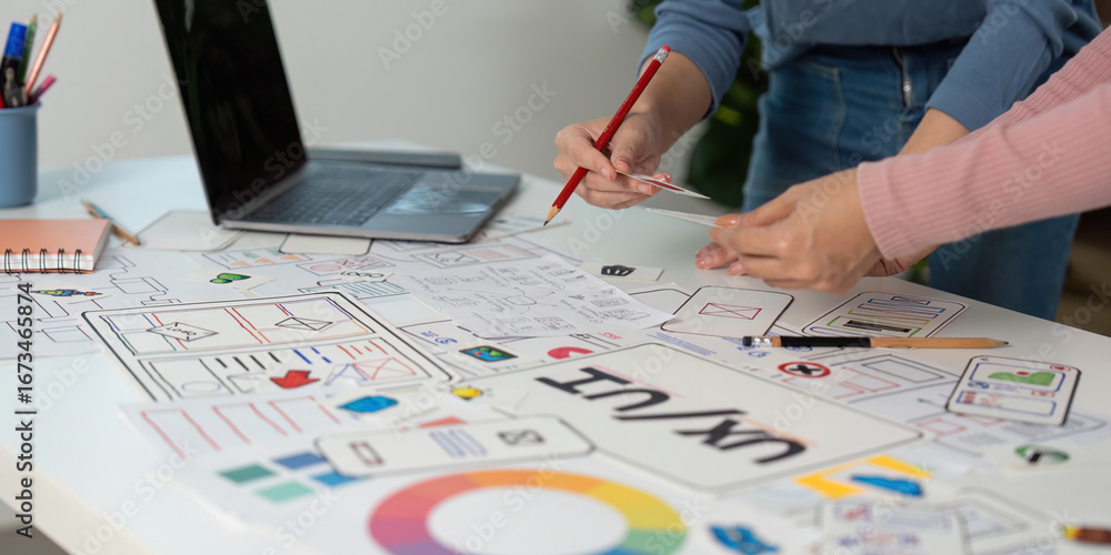Aufkleber creative ux and ui design process. team members sketching and refining wireframes in a collaborative