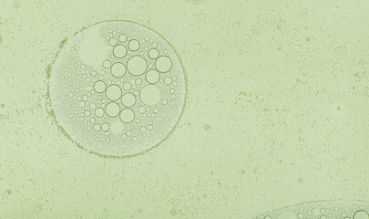 Macro microscope green bubble texture, Close-up Green bubbles and drops oil background . blue green water bubbles, close up golden oil drop for cosmetic