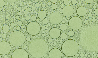 Macro microscope green bubble texture, Close-up Green bubbles and drops oil background . blue green water bubbles, close up golden oil drop for cosmetic