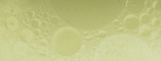 Macro microscope green bubble texture, Close-up Green bubbles and drops oil background . blue green water bubbles, close up golden oil drop for cosmetic