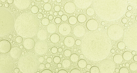 Macro microscope green bubble texture, Close-up Green bubbles and drops oil background . blue green water bubbles, close up golden oil drop for cosmetic