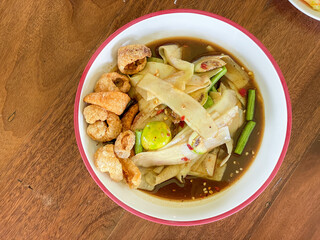 Classic Thai Somtam (Thai Somtam) served on a wooden table. Famous and refreshing menu The concept...