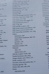 A close-up of an open medical textbook, showing detailed text and diagrams about human physiology and biology. This image represents study, education, research, and the journey of a medical student.