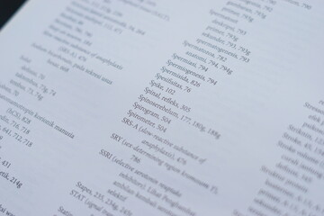 A close-up of an open medical textbook, showing detailed text and diagrams about human physiology and biology. This image represents study, education, research, and the journey of a medical student.