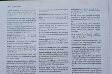 Fototapeta premium A close-up of an open medical textbook, showing detailed text and diagrams about human physiology and biology. This image represents study, education, research, and the journey of a medical student.