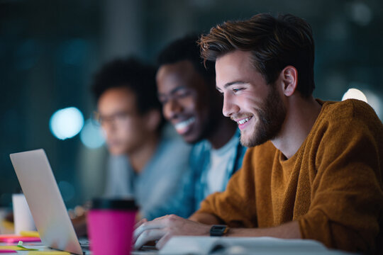 Diverse team working late, illuminated by laptop screens. Collaboration, innovation, and teamwork, showcasing dedication and achieving goals together.