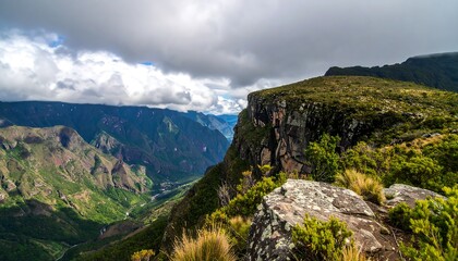 Fototapeta premium Dramatic Cliff Edge Overlooking a Lush Green Canyon Landscape.