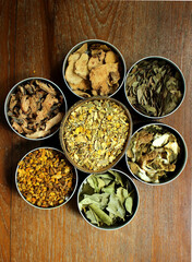 Assorted Thai Dried Herbs Arranged in Round Bowls for Spa, Herbal Medicine, and Organic Wellness Flatlay