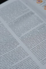 A close-up of an open medical textbook, showing detailed text and diagrams about human physiology and biology. This image represents study, education, research, and the journey of a medical student.