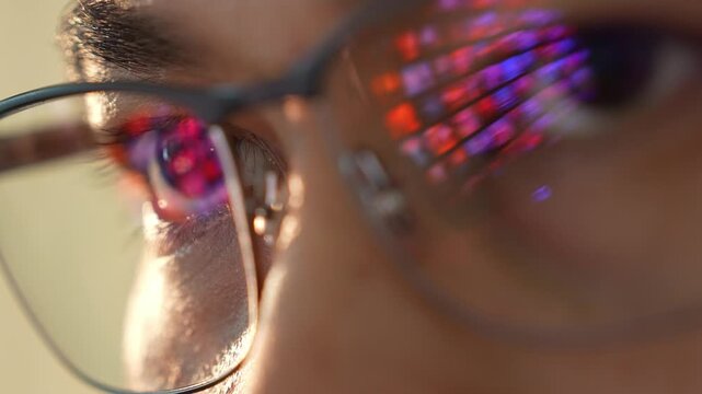 Reflections of a luminous screen dance in the eyes behind glasses, symbolizing technology, curiosity, remote work, adaptation to digital life, and continuous self-improvement.
