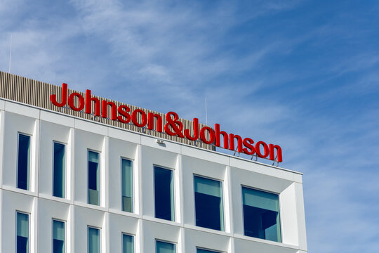 The "Johnson & Johnson" logo in red letters on top of a modern corporate building against a light blue sky. Leiden, Netherlands, 3 May 2025.