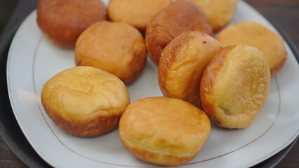 Plate of Homemade Fried Donuts on a Wooden Table