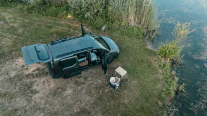 Remote campervan spot by lake in Bavaria drone view showing the spirit of wild camping van life and peaceful travel © Thilo Wagner