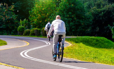Fototapeta premium Cyclist ride on the bike path in the city Park 