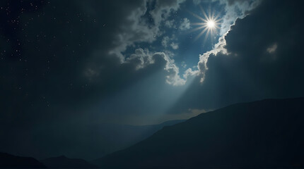 Majestic mountains under a dramatic sky with sun rays piercing through clouds