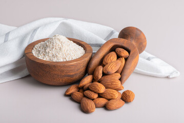 Almonds and almond flour in bowl on table. Almond flour high in protein.	