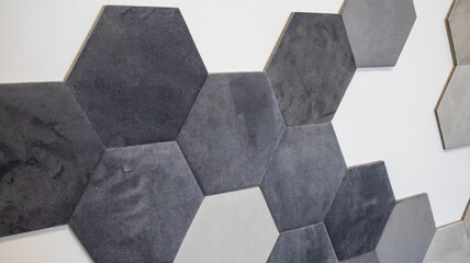 Modern interior design with soft black and grey hexagonal wall panels. Stylish acoustic decoration...