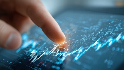 Hand touching digital stock chart on tablet