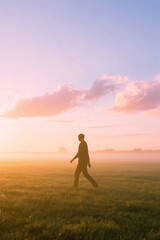 silhouette of person with dreamy sky and clouds background