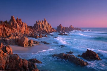 Sunrise paints rugged coastline rocks fiery hues, waves crash gently on the shore
