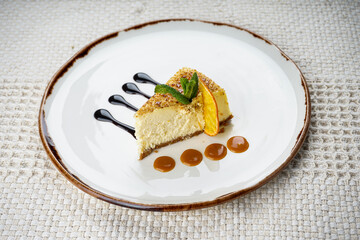 Cheesecake dessert in a white plate on a white background