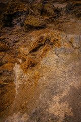 Golden and brown geothermal rock formations in Iceland show layers of mineral rich earth shaped by volcanic heat and steaming hot springs