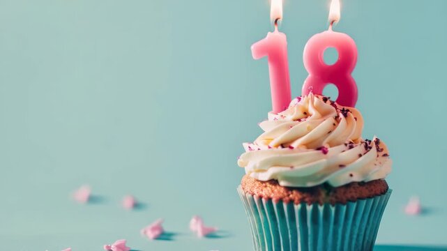 Sweet 18th birthday celebration with a vanilla cupcake topped with edible decorations and red candles. - Powered by Adobe