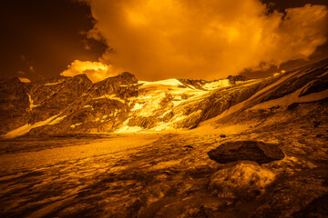 Fantasy orange effect color of the Barba d'Orso Glacier surface and seracs, with strange ice mushroom, Vallelunga, Alto Adige - Sudtirol, Italy. Abstract image