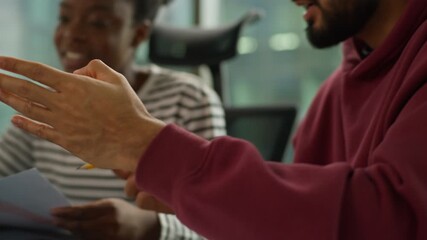 Informal business team collaboration Arabian man examining papers African woman holding chart comunicate Indian male colleague pointing at laptop casual diversity teamwork modern office briefing job - Powered by Adobe