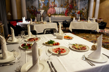 variety of dishes on served tables in a restaurant on plates