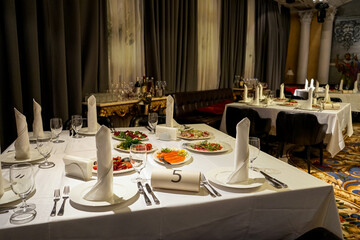 strict interior with served tables in a palace-style restaurant