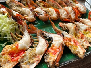 Grilled river prawns, split in half and served with extras.