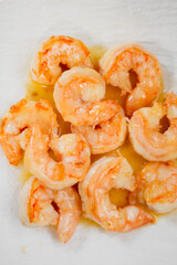Cooked shrimps in oil with shiny texture. Close up of boiled seafood prawns, ready to eat, isolated on background for menu, restaurant, food styling or healthy gourmet concept