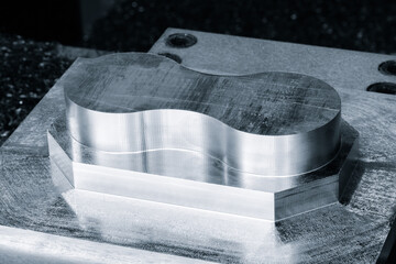 Metal part made by metalworking CNC machine from a solid piece of metal. Metalworking concept background