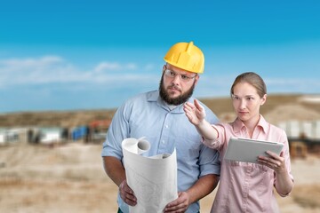 Two workers at work at construction site