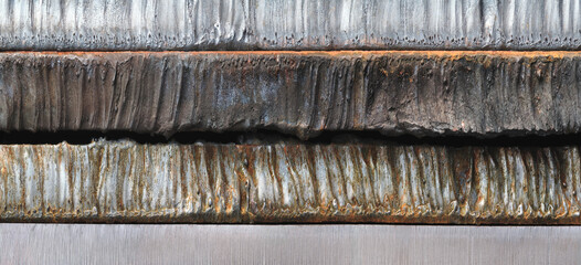 Stack of  thick heavy metal plates rusty uneven surface after laser cutting. plates stacked top...