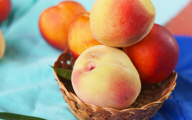 Smooth peaches in a basket on the table