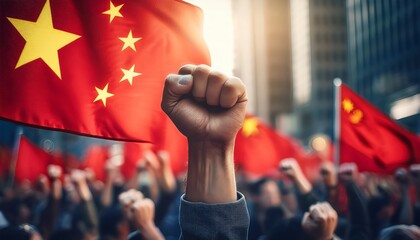 A raised fist in front of China’s flag symbolizes resistance and unity during a crowded demonstration. The image conveys determination and collective strength amid national colors.